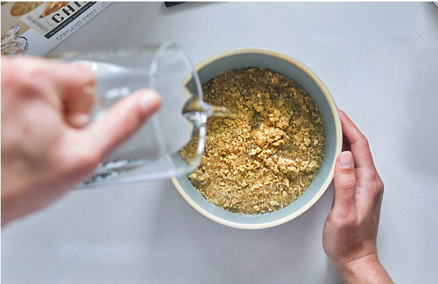 Adding warm water to Dog-o-Meals - the food absorbs and expands